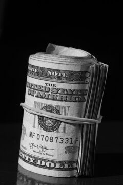 twisted stack of twenty-dollar American dollar banknotes