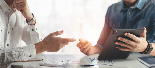 Businessman advisor, two business people talking, planning analyze investment and marketing on tablet in office.