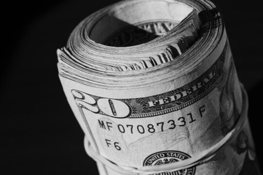 twisted stack of twenty-dollar American dollar banknotes