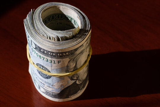 twisted stack of twenty-dollar American dollar banknotes