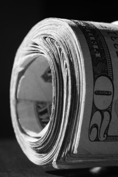 twisted stack of twenty-dollar American dollar banknotes