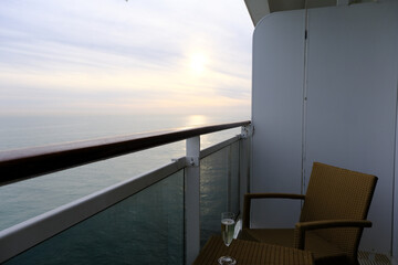 Balcony verandah of luxury cruiseship cruise ship liner stateroom cabin suite with rattan seats and...