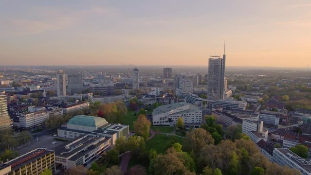 Essen City Skyline, Theater and Park at dawn, aerial pull back view, Ruhr area Germany