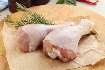 Raw chicken leg over board