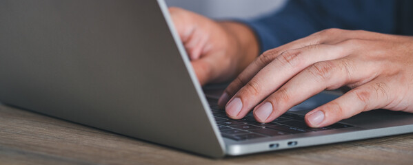 Businessman or student wearing white shirt using laptop for searching, working, online learning, marketing, studying, distance education network online technology background.selective focus.