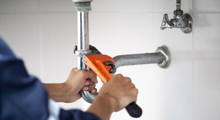 plumber at work in a bathroom, plumbing repair service, assemble and install concept.
