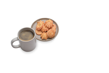 Plate with Danish butter cookies and coffee cup isolated on white background with copy space.