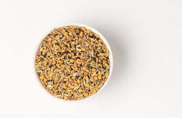 Panch phoron  or panchpuran  Indian and Bengal five spice seeds  blend for cooking  consisting of fenugreek, fennel, cumin, mustard seeds, onion seeds or black cumin in bowl on white background