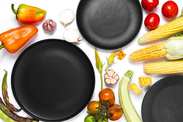Creative layout made of autumn vegetables. Tomatoes, onion, carrot, garlic, red beet, pepper,...