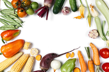 Creative layout made of autumn vegetables. Tomatoes, onion, cucumber, carrot, garlic, red beet,...