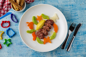Turkish meatball traditional kofte. with carrots and zucchini cut into animal shapes. Spicy Meatballs Kebab or Kebab