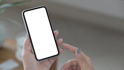 Mockup image of woman hands holding mobile phone with blank screen for your advertising text.