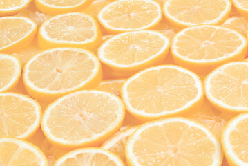 A slices of fresh juicy yellow lemons.  Texture background, pattern.