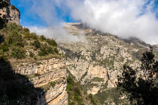 Panoramic view on the cloud covered peaks of Monte Molare, Canino, Caldare in Lattari Mountains, Apennines, Amalfi Coast, Italy, Europe. Rock formation on hiking trail near the coastal town Positano