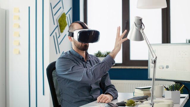 Executive manager using virtual reality glasses in startup office, working with vr headset with interactive vision technology. Business man enjoying modern goggles with 3d simulation tech.