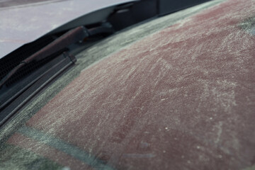 Fototapeta na wymiar desert sand on car window in germany a normal weather phenomenon in spring