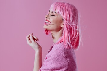 Portrait of a charming lady modern style pink hair Red lips fashion pink background unaltered