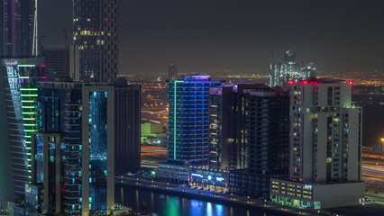 Obraz na płótnie Canvas Skyscrapers at the Business Bay aerial night timelapse in Dubai, United Arab Emirates