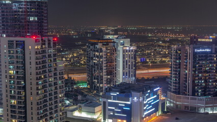 Fototapeta na wymiar Skyscrapers at the Business Bay aerial night timelapse in Dubai, United Arab Emirates