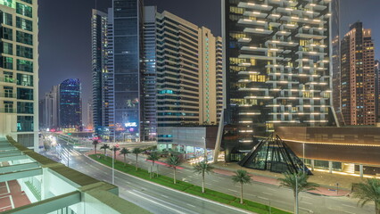 Fototapeta na wymiar Modern city architecture in Business bay district. Panoramic view of Dubai's skyscrapers night timelapse