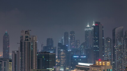 Dubai skyscrapers with illumination in business bay district night timelapse.