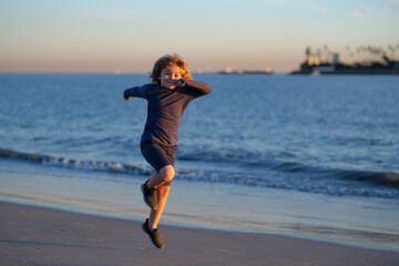 Kids running outdoors. Run and healthy sport for children. Child running on summer field near sea, kids fitness. Summer vacation with child.