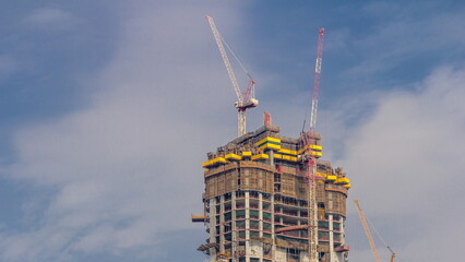 Cranes working on modern constraction site works of new skyscraper timelapse