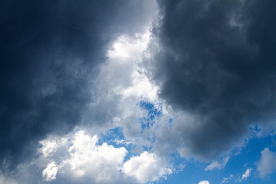 Dark storm clouds on blue sky