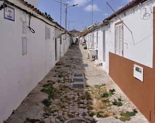 Small narrow alley in a fishing settlement in Olhao, Algarve - Portugal
