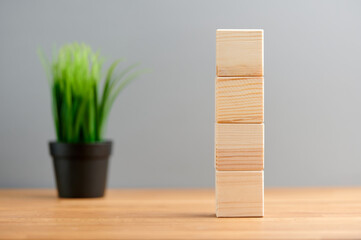 Ecology, business, seo, team, advertise concept, blank wooden block cubes on a gray background with plant for your text and advertisement. Free space for business concept template and banner..