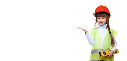 Building, construction and profession concept. Preschool child girl wearing construction vest and building helmet holds building level on white isolated background