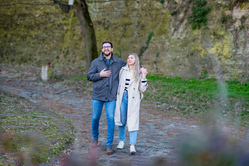 Fototapeta premium A portrait of a happy romantic couple walking outdoors in the surroundings of an old fortress