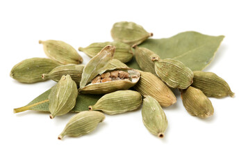 Green cardamom pods and Aromatic bay leaves on white background