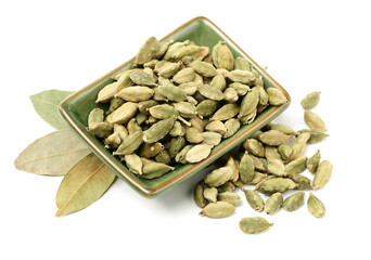Green cardamom pods and Aromatic bay leaves on white background
