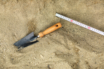 Shovel in the sand.Skeleton and archaeological tools.Digging for fossils.