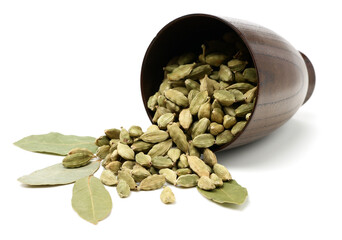 Green cardamom pods and Aromatic bay leaves on white background
