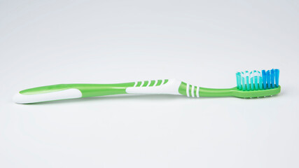 Green toothbrush for teeth on the white background