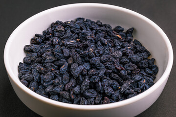 black raisins (unakka munthiri) in white bowl