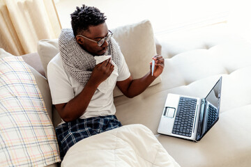 Young man getting online medical help and advice during video call with female doctor and checking...
