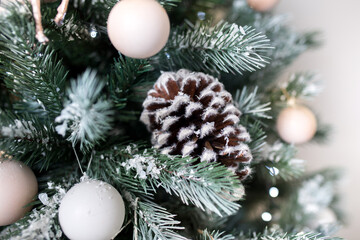 Fototapeta na wymiar Christmas balls and toys on the Christmas tree, Christmas decorations and white decor, Christmas fir-cone