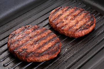 Grilled vegan meat made of vegetable fats and proteins. Patty made of vegan meat.