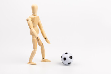 Wooden mannequin with soccer ball isolated on white background. Football player concept.