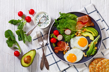 fried eggs, lettuce, avocado, radish, peanuts, ham