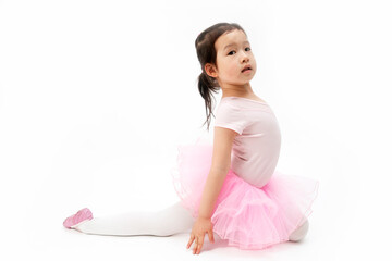 The beautiful little girl is doing gymnastics on a white background