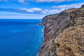 Rocky coast of Madeira with cliffs, coast of the island