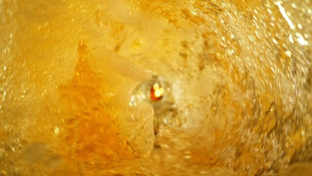 Super Slow Motion Shot of Fresh Beer Whirling in Glass Bottle at 1000fps.