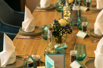 Turquoise table decoration with chocolate balls and glasses