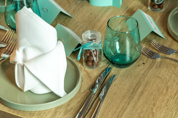 Turquoise table decoration with chocolate balls and glasses