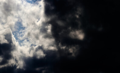 Fototapeta na wymiar Dramatic sky. Blue sky and black and white clouds. Thunderstorms sky. 