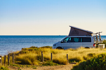 Camper van with roof top tent camp on beach